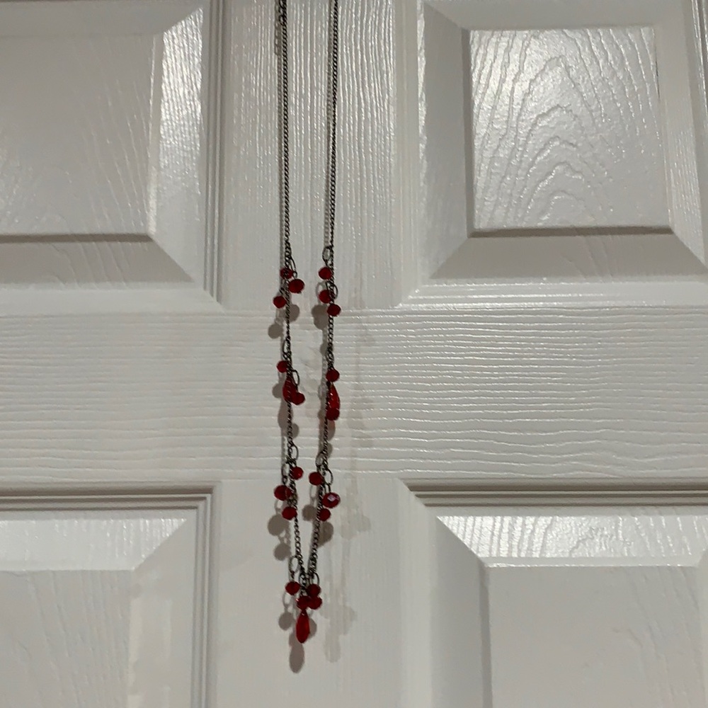 Long necklace with ruby colored jewels
